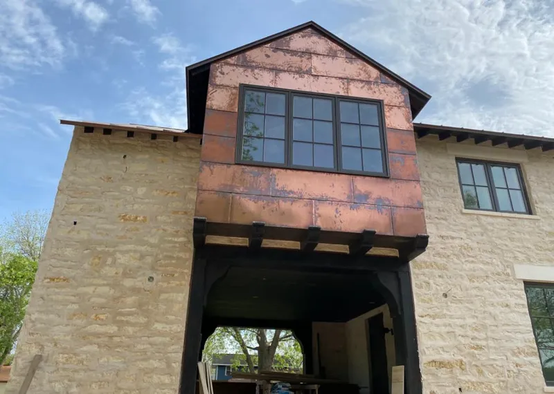 Copper metal panel facade on a stone building for Skylight Installation in East Los Angeles