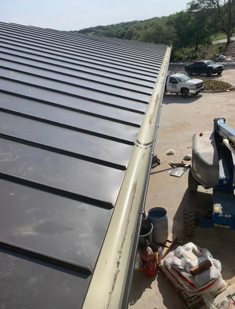 Standing seam panel and gutter detail on a metal roofing jobsite in East Los Angeles